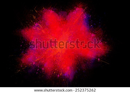 Freeze motion of colorful powder paint exploding isolated on black dark background. Abstract design of color dust cloud. Particles explosion screen saver, wallpaper, brush