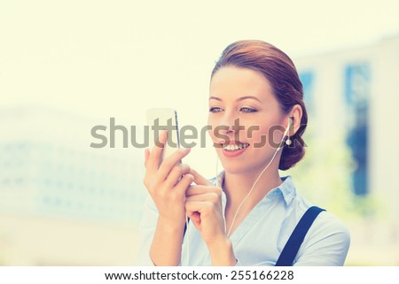 Closeup portrait happy cheerful girl excited by what she sees on cell phone isolated background corporate office. Face expression reaction. Business woman sending text message from mobile smartphone