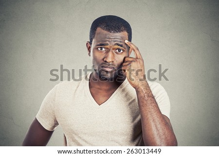 Preoccupied man scratching his head looking for solution