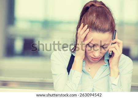Portrait unhappy young woman talking on mobile phone looking down. Human face expression, emotion, bad news reaction