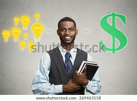 Happy, smiling handsome man holding books has ideas ready for financial success isolated on black grey wall background. Positive human facial expression feeling, emotion. Education economics concept