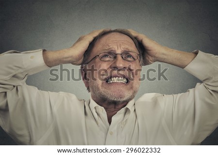 Closeup portrait headshot furious frustrated elderly man having bad hard day screaming looking up isolated on gray wall background. Negative face expression emotion