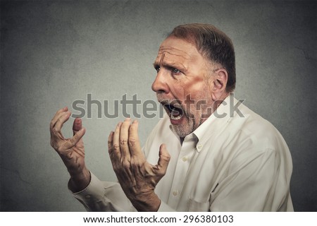 Side profile portrait of senior angry man
