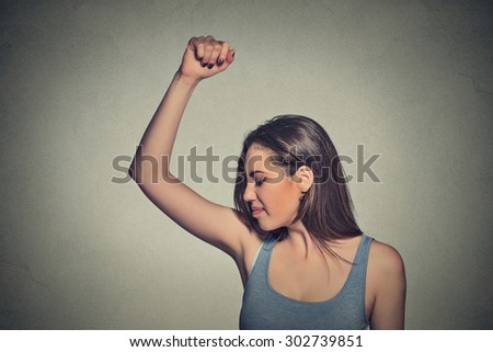 Closeup portrait young woman, smelling, sniffing her wet armpit, something stinks, very bad foul odor situation isolated grey wall background. Negative human emotion facial expression feeling reaction