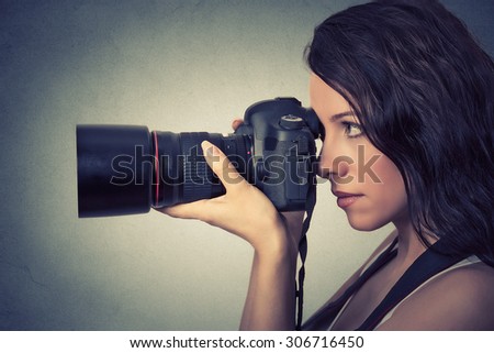 Side profile young woman taking pictures with professional camera