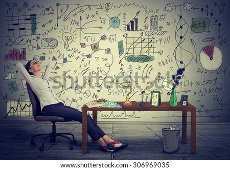 Young business woman relaxing at her desk in her office
