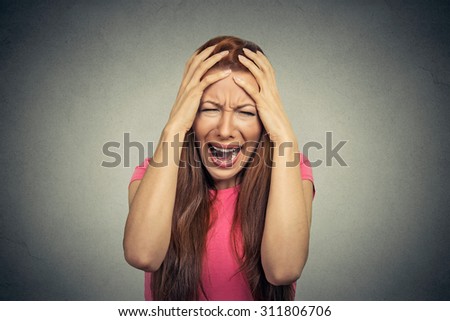 Closeup portrait stressed frustrated woman yelling screaming having temper tantrum isolated on gray wall background. Negative human emotion facial expression reaction attitude
