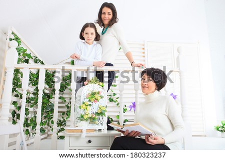 Cute little girl, her mother and grandmother together on this portrait