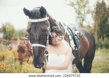 The bride in white dress with horse.