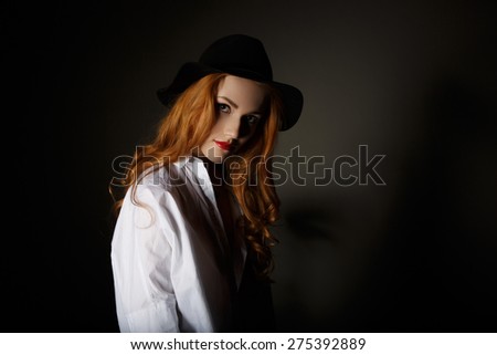 Very Beautiful  Woman on the Dark Background of Dark Grey Wall