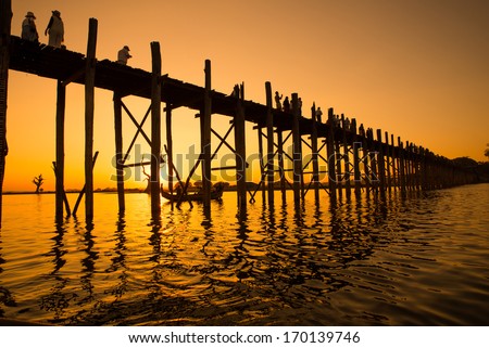 Bridge U-Bein teak bridge is the longest. Sunset with silhouettes of people unrecognizable