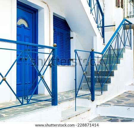 Greek island street with colorful shutters and doors.