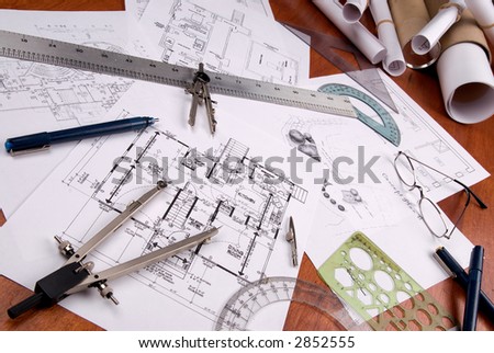 engineer, architect or contractor plans and tools laid out on a wooden table