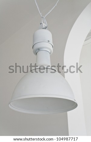 White ceiling lamp in large hall