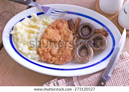 Wiener Schnitzel - breaded meat with potato and mushrooms