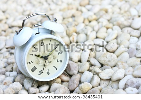 Alarm clock on stones.