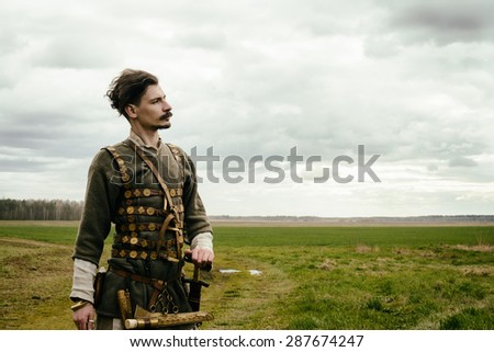 man in ethnic suit in context of historical reconstruction outdoor
