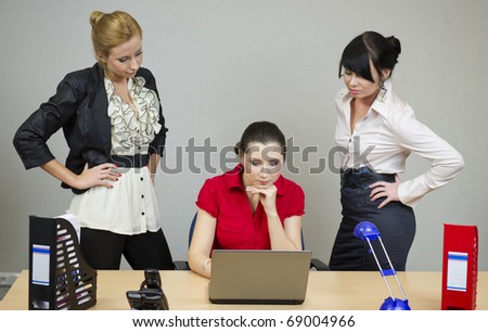 Two women in the office watching his girlfriend at work