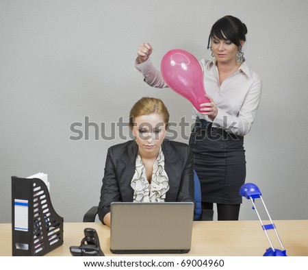 worker in the office creeps up behind the girls, she wants to break the inflated balloon and it really scared