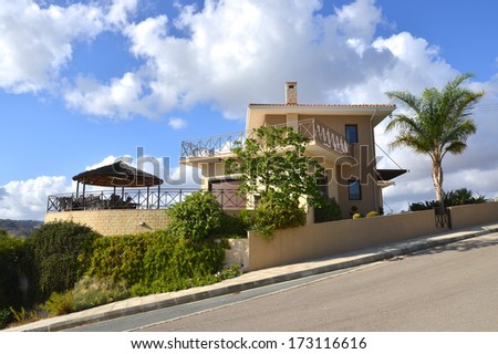 Vacation villa house for rent in cyprus surrounded by palm tree and blue sky