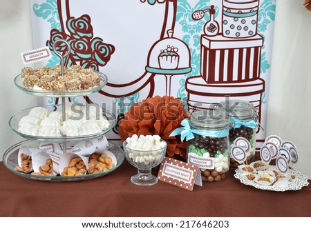 Homemade fancy set table with sweets candies, cake, marshmallows, zephyr, nuts, almonds, truffle as a present for birthday party