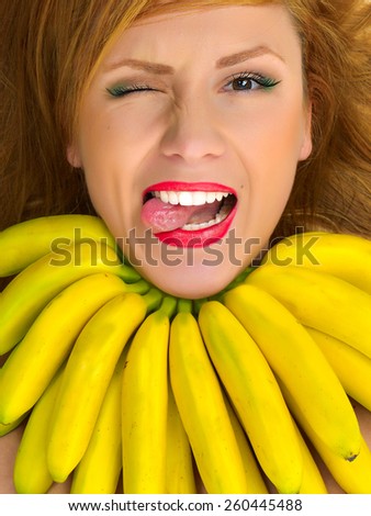 Closeup portrait of fashion woman with necklace of small yellow bananas smiling