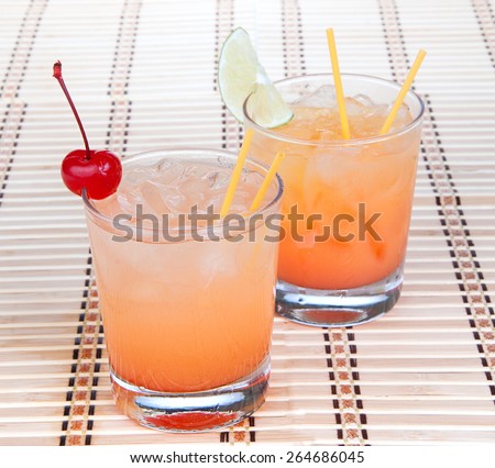 Alcohol margarita cocktails or long island Iced tea with lime in short cocktail glasses isolated on a white background