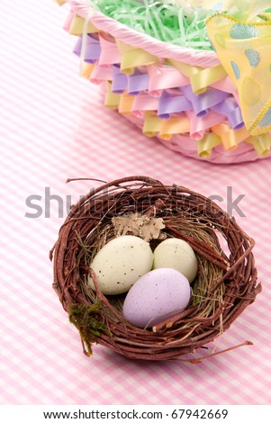 Easter Painted Colorful eggs in birds nest  for sunday morning on a pastel color background