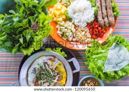 traditional northern thai native food set made with pork chop stick mix whit fresh vegetable herbs wrap with thin stream powder sheet dip in sauce with egg fried pan