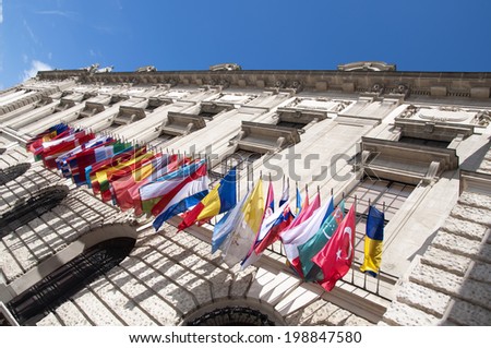 VIENNA, AUSTRIA - MAY 4: Flags on Hofburg palace on May 4, 2014 in Vienna. The Imperial Palace Hofburg is the most representative example of Vienna\'s characteristic variety of architecture styles.
