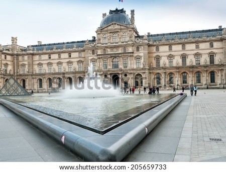 PARIS, FRANCE - MARCH 27: Louvre museum on March 27, 2014 in Paris. The museum is housed in the Louvre Palace, originally built as a fortress in the late 12th century under Philip II.