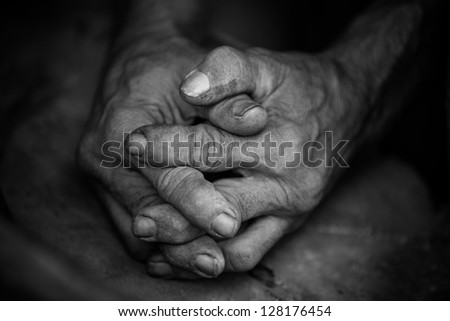 Black and white image of a pair of old hands clasped together