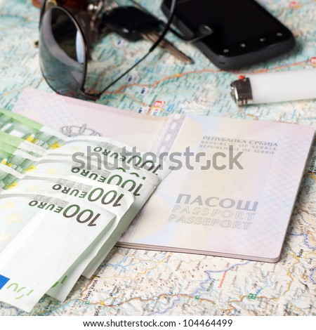 Getting ready for a trip - European passport, sunglasses road map and euros.