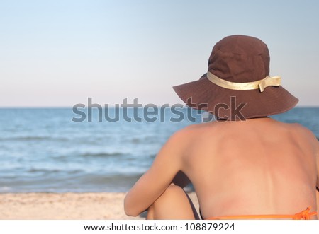 Travel woman reads book on the beach