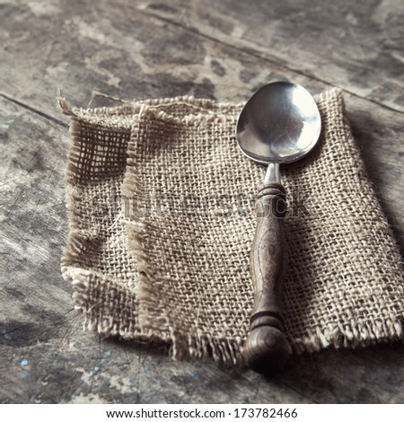 Spoon on a rustic wooden bakground, natural light