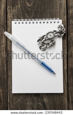 Watch And Pen On The Top Of The Notebook, from above