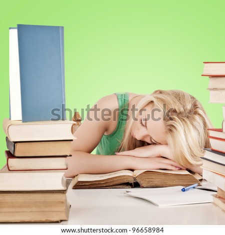 Tired student fell asleep on books
