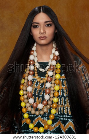 Woman in ethnic dress with long hair in the studio portrait