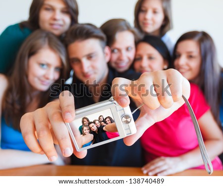 Young people taking picture of themselves with camera - selfpic series.