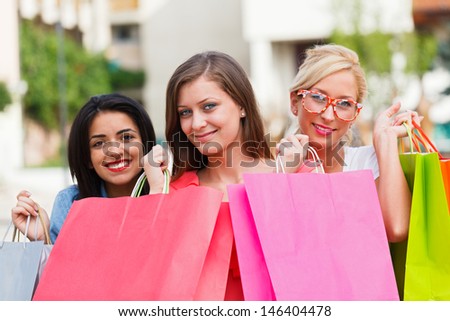 Beautiful girls out with many shopping bags in the city center and enjoying their time together.