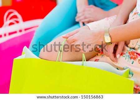 Many women with many colorful shopping bags.