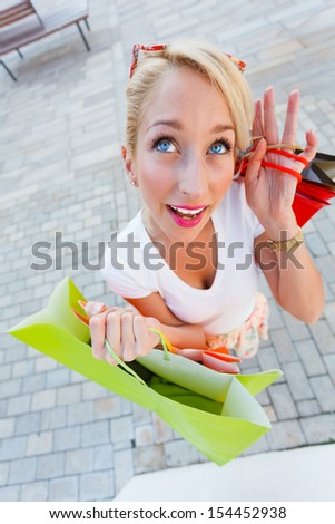 Women with colorful shopping bags from wide angle.