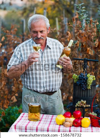Wine expert smelling athe product of the last year after harvest.