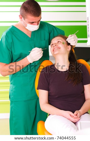 A young female patient at the dentist smiling,  being happy for the dental treatment.