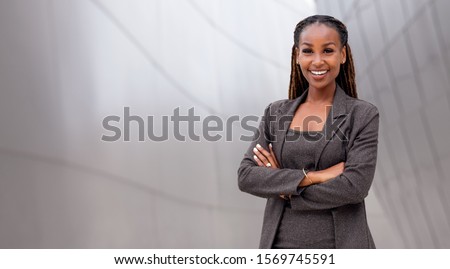 Similar – Image, Stock Photo Confident African American woman in stylish outfit at entrance of contemporary building with orange tiled facade