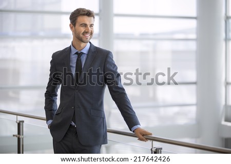 Friendly and smiling businessman looking at the horizon