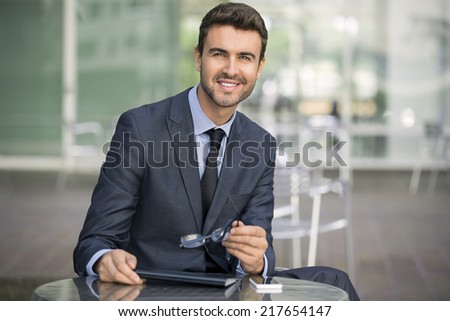 Attractive business man real estate stock market person with perfect smile wearing a nice suit