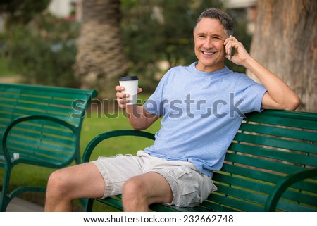 Elder man talking on the phone in the park