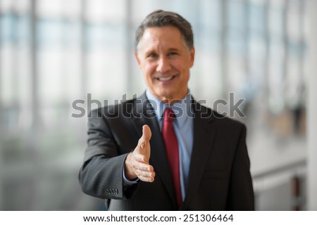 Mature business man giving a handshake