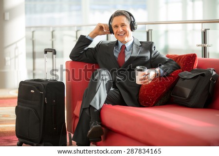 Executive man on business travel trip relaxes early for his flight